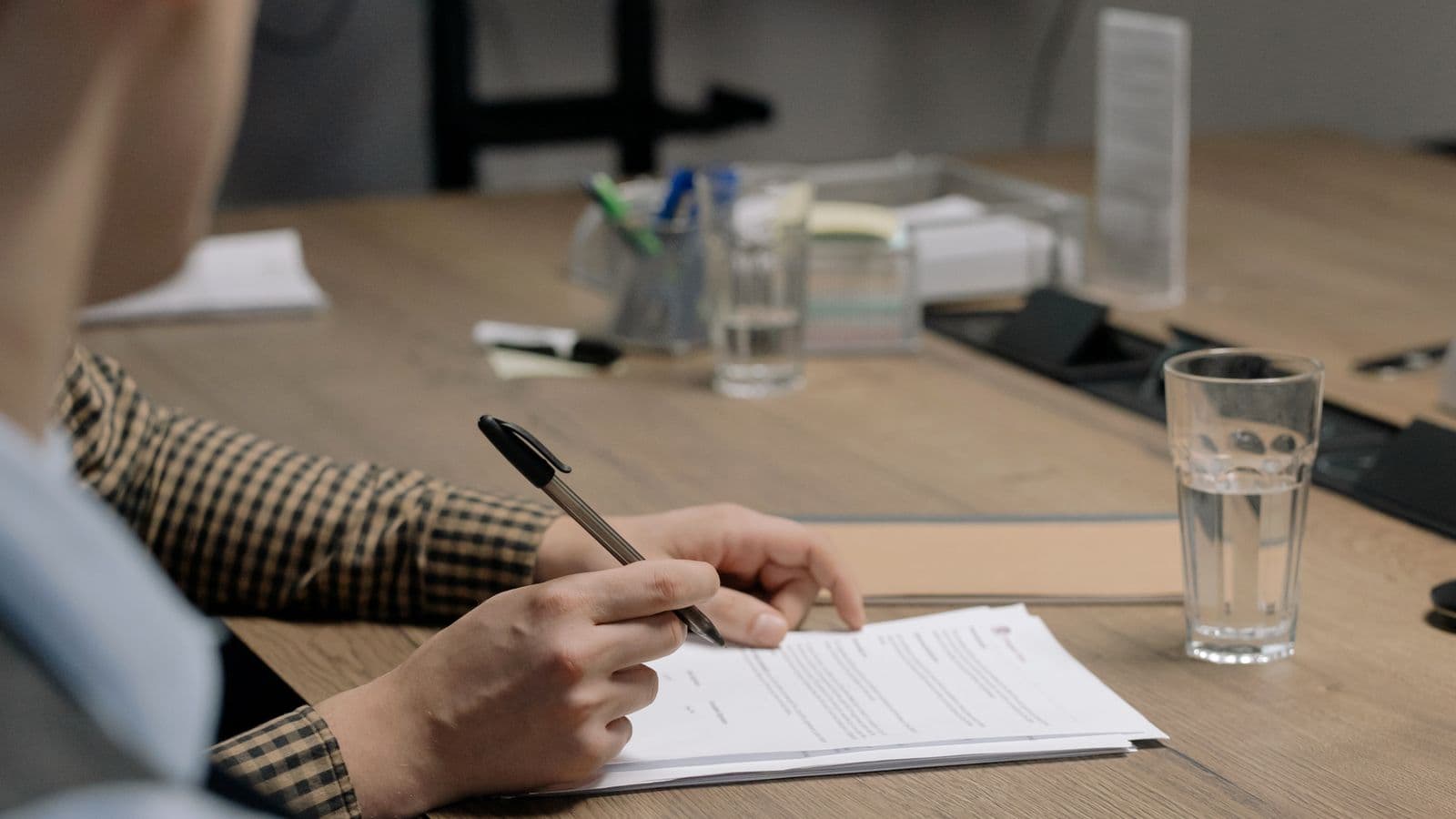 Artisan signant un devis de nettoyage de toiture sur une table